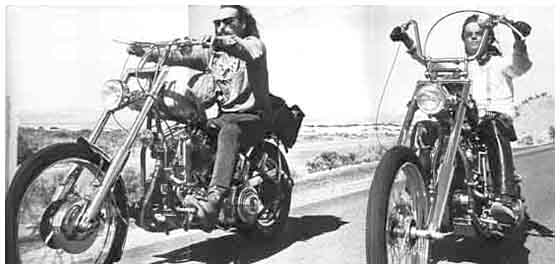 B & W photo of Peter and Dennis (Wyatt and Billy in the film) shot side by side cruising along a desert road