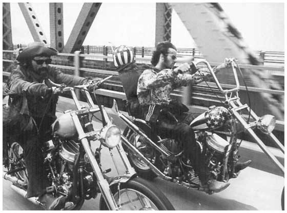 B & W photo of Peter and Dennis (Wyatt and Billy in the film) riding over a bridge side by side